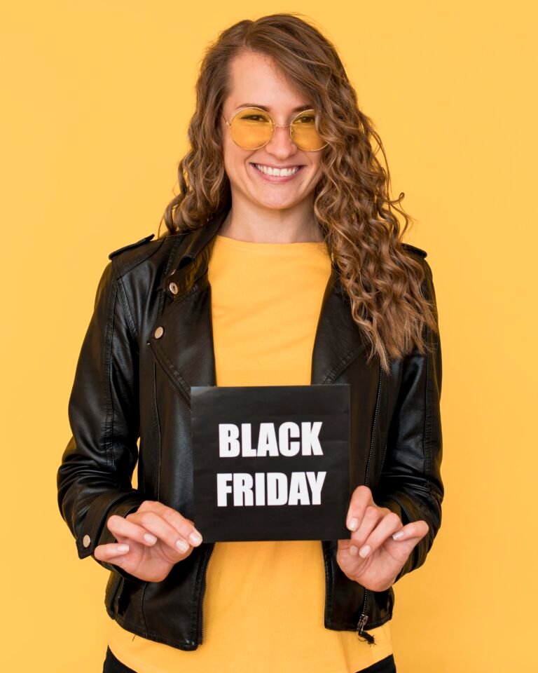 woman wearing glasses holding black friday label